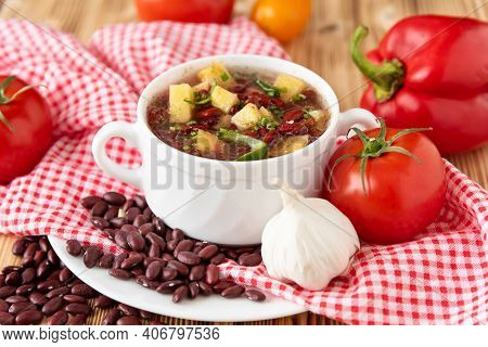 Bean Soup With Meat In A White Ceramic Bowl.