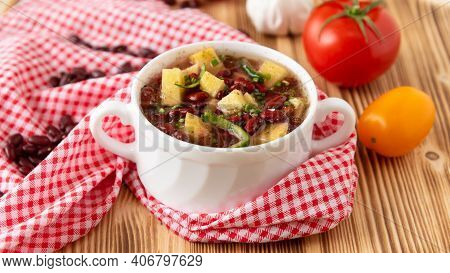 Bean Soup With Meat In A White Ceramic Bowl.