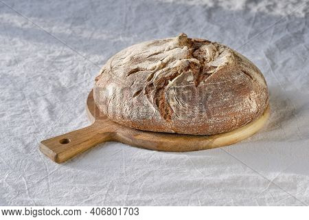 No Knead Handmade Loaf On Cutting Board. German Bauernbrot Means Farmers Bread In English. Wholemeal