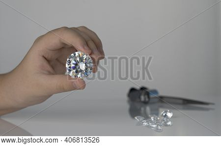 Close Up Large Round Shape Polished Diamond In Hand. Evaluating Diamond By Jeweller And Expertise. B