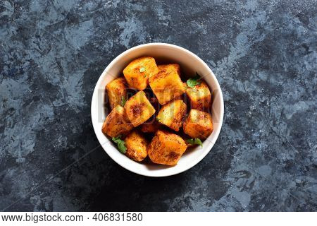 Pan Fried Paneer. Indian Roasted Cottage Cheese Bites In Bowl Over Blue Stone Background With Free T