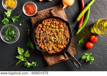 Keema Curry In Frying Pan Over Black Stone Background. Indian And Pakistani Style Dish. Top View, Fl