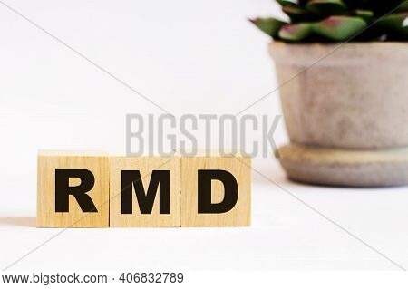 On A Light Background, Wooden Cubes With The Inscription Rmd Required Minimum Distributions And A Fl