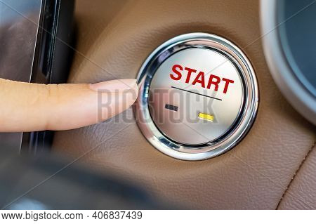 Finger Press A Car Ignition Button Or Start Engine Inside Modern Electric Automobile. Keyless, Chang