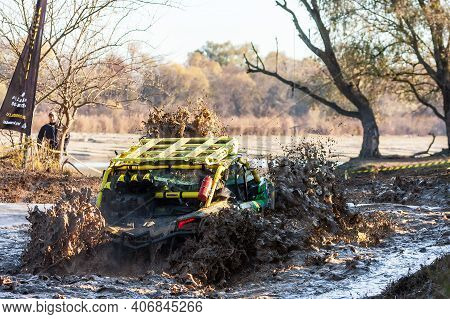 Afipsip, Russia - October 31, 2020: Sportsman On Buggy Drives Splashing In Deep Water At Mud Racing 