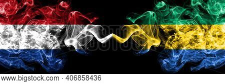 Netherlands Vs Gabon, Gabonese, Gabonian Smoky Mystic Flags Placed Side By Side. Thick Colored Silky
