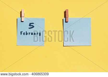 5st Of February. 5st Day Of The Month, Calendar Date. Two Blue Sheets For Writing On A Yellow Backgr