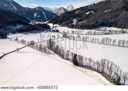 Aerial Winter Landscape With Mountain Village And Forest Covered In Snow. Zgornje Jezersko, Slovenia