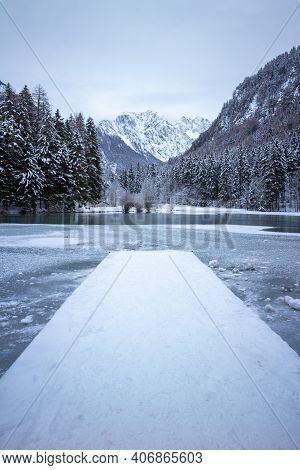 Frozen Winter Lake In The Mountains Covered With Snow. Plansar Lake, Jezersko Slovenia.