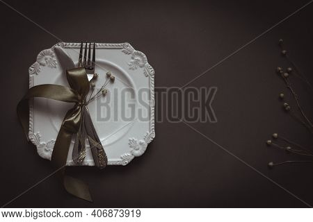Romantic Tabble Setting With Ribbon, Plates, Cutlery On Black Background. Empty Plate. Mockup Design