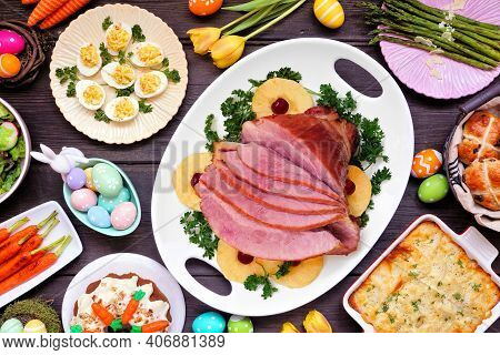 Traditional Easter Ham Dinner. Above View Table Scene On A Dark Wood Background. Ham, Scalloped Pota