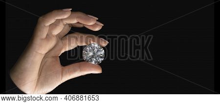Large Polished Round Cut Diamond In Hand Close Up Front View. High Quality Photo