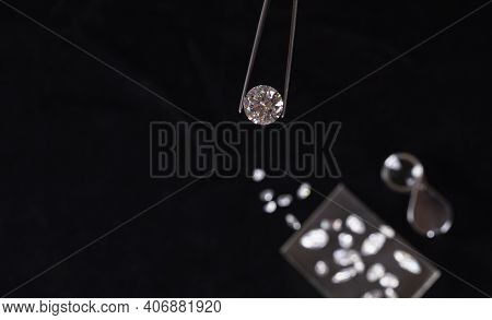 Large Polished Round Cut Diamond In Hand Close Up Front View. High Quality Photo