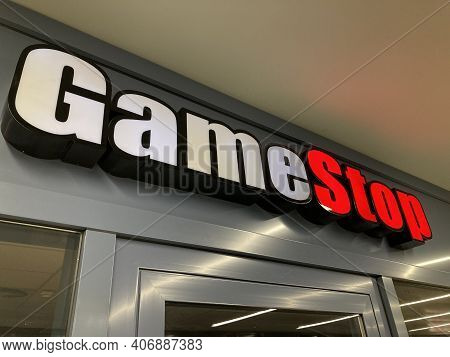 Zug, Switzerland - 6th February 2021 : Gamestop Logo Hanging Over A Store Entrance In Zug, Switzerla