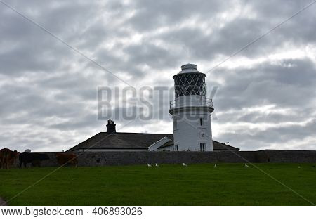 Gray Storm Clouds Surrounding St Bees Lighthouse In England.