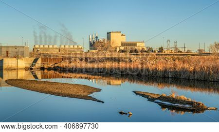Fort Saint Vrain Generating Station near Plateville, Colorado, originally built as a nuclear power plant, currently powered by natural gas, distant view with St Vrain Creek in front