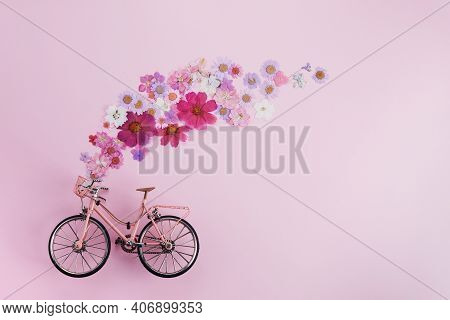 Flowers Fly Out From Pink Bicycle Bascet On Pink Background. Romanitic Concept For Valentine Day, Wo