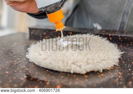 A Professional Worker Applies A Special Polishing Paste To The Polishing Tool. Car Polishing. Stone 