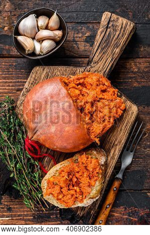 Sobrassada Cured Pork Meat Sausage On Bread Slice. Dark Wooden Background. Top View
