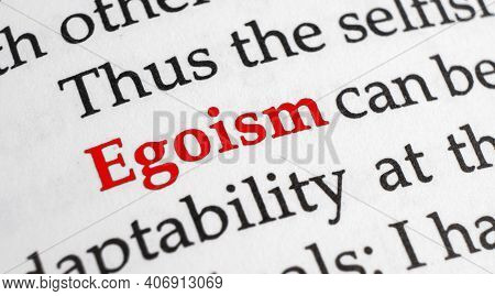 Selective Focus On The Red Word Egoism. Macro Shot Printed Red Colour Word Egoism On A Piece Of Pape