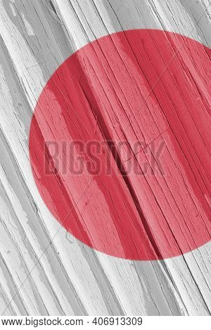 Fragment Of Japan Flag On A Dry Wooden Surface, Cracked With Age. Light Pale Faded Paint. Vertical B