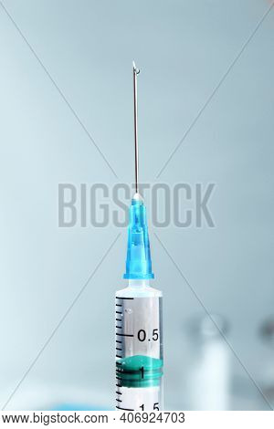 Syringe With The Drug Inside. Background For Vaccination. Close-up Of A Syringe Needle. Selected Foc