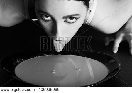 Woman In Lingerie Laps Milk From Bowl On Floor, Looking At Camera, Monochrome