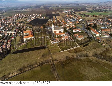 Sumuleu Ciuc, Romania- 07 February 2021: Aerial View , Local Catholic Church, One Of The Most Visite