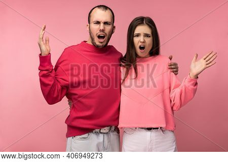 Photo Of Attractive Man Wih Beard In Red Clothing And Woman In Pink Are Dreadly Sorehead, Isolated O