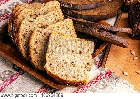 Slices of wheat and oat flakes bread and rye bread.