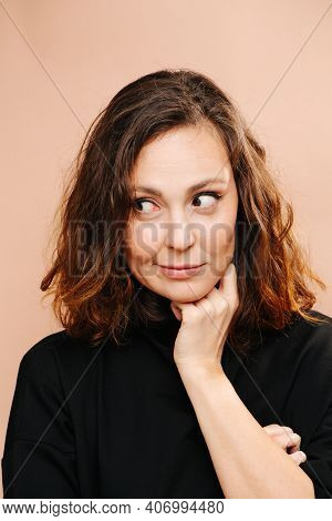 Sceptical Smile On A Face Of Middle Aged Woman, Hand Of Her Neck.