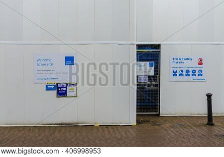Chester; Uk: Jan 29, 2021: Safety Notices Are Displayed Prominently On Plain Hoardings Around A Buil