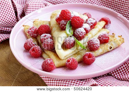 pancakes (crepes) with raspberries and mint -  healthy breakfast