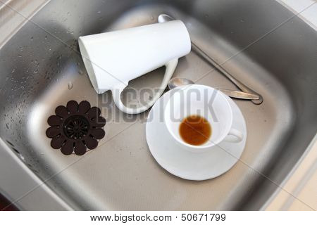 Dishwashing. White Dishes In The Kitchen Sink.