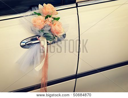 Door Of White Wedding Car With Flowers And White Bow