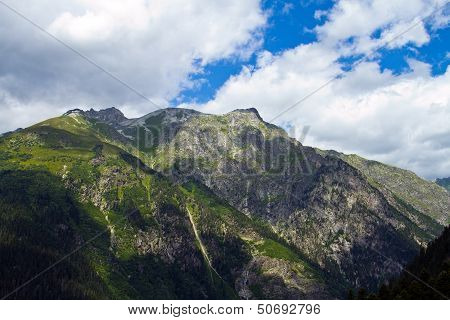 Mountain peaks in Dombai. Summer in cloudy weather