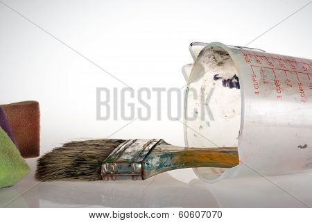 brush, measuring cup, sponges