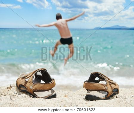holiday concept. man jumping into the torquoise tropic sea at vacation