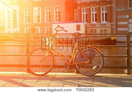 Amsterdam view with bicycles under sun light