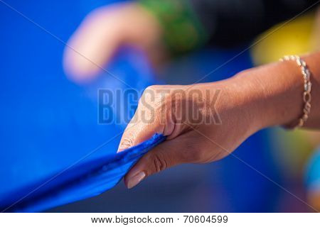 ODESSA, UKRAINE - August 23: Flash mob in city of Odessa on Potemkin Stairs on August 23, 2014, in day of a national flag of Ukraine. Hands of participants of Flash mob in Odessa with a flag