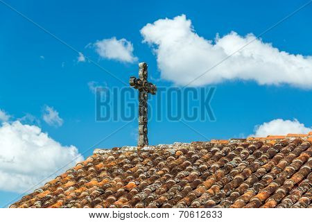 Cross And Tiled Roof