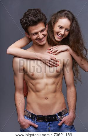 Shirtless young couple embracing