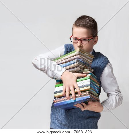 Schoolboy in glasses with books