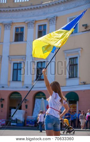 ODESSA, UKRAINE - August 23: Flash mob in city of Odessa on Potemkin Stairs on August 23, 2014, in day of a national flag of Ukraine. Happy participants of summer Flash mob with a flag