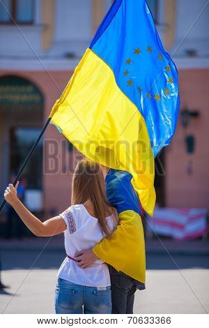 ODESSA, UKRAINE - August 23: Flash mob in city of Odessa on Potemkin Stairs on August 23, 2014, in day of a national flag of Ukraine. Happy participants of summer Flash mob with a flag