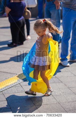 ODESSA, UKRAINE - August 23: Flash mob in city of Odessa on Potemkin Stairs on August 23, 2014, in day of a national flag of Ukraine. Happy participants kids of summer Flash mob with a flag