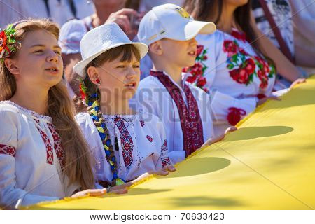 ODESSA, UKRAINE - August 23: Flash mob in city of Odessa on Potemkin Stairs on August 23, 2014, in day of a national flag of Ukraine. Happy participants of summer Flash mob with a flag