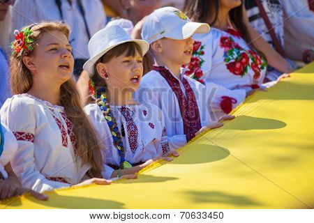 ODESSA, UKRAINE - August 23: Flash mob in city of Odessa on Potemkin Stairs on August 23, 2014, in day of a national flag of Ukraine. Happy participants of summer Flash mob with a flag