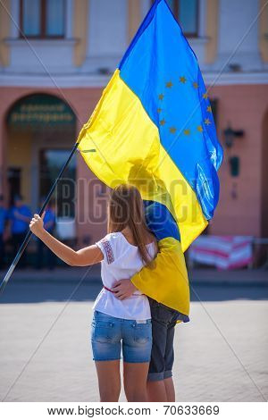 ODESSA, UKRAINE - August 23: Flash mob in city of Odessa on Potemkin Stairs on August 23, 2014, in day of a national flag of Ukraine. Happy participants of summer Flash mob with a flag