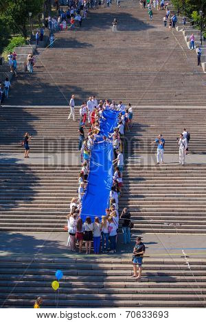 ODESSA, UKRAINE - August 23: Flash mob in city of Odessa on Potemkin Stairs on August 23, 2014, in day of a national flag of Ukraine.